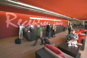 a group of people standing around a counter in a store at Rosenberger Motor-Hotel Ansfelden in Linz