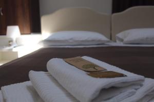 a hotel room with towels on a bed at Time Out ApartHotel in Casalecchio di Reno
