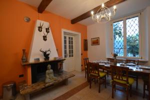 a dining room with a table and a fireplace at Villa Rina Deluxe and Cottage in Porto Ceresio