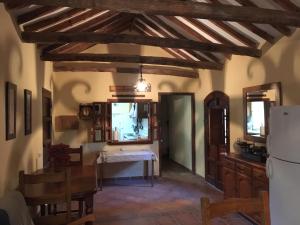 a kitchen with a table and a refrigerator at CASA CAMPO in Manilva