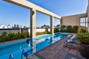a swimming pool on the roof of a building at Double Tree by Hilton São Paulo Itaim in Sao Paulo