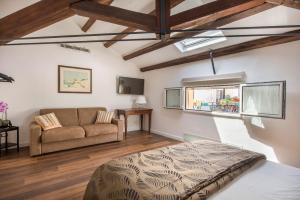 a living room with a bed and a couch at B&B Villa Liberty sul mare in Palermo +56 photos