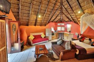 
a living room filled with furniture and decor at Manzini Chalets in Marloth Park
