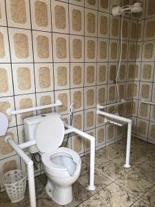 a bathroom with a toilet and a shower at Residencial dos Portugas in Boracéia