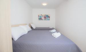 Un pat sau paturi într-o cameră la Apartment Rita
