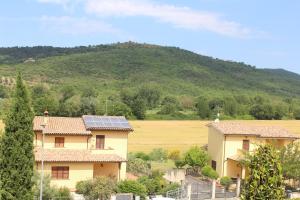 a house with solar panels on its roofs in front of a hill at Monolocale Azzurra in Magione