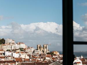 a large building with a sky background at Dear Lisbon - Palace Chiado Suites in Lisbon