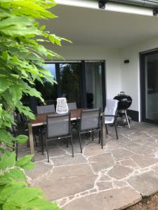 a patio with a wooden table and chairs at Appartement Elzerland in Mayen