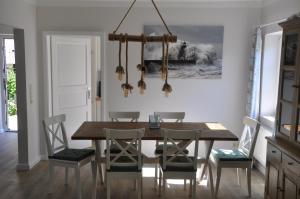a dining room with a wooden table and chairs at Fischerhus in Fehmarn