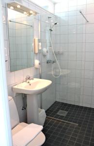 a bathroom with a sink and a shower at Vätterleden Hotell & Restaurang in Gränna