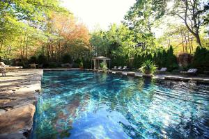 a swimming pool with blue water in a yard at The White Barn Inn & Spa, Auberge Resorts Collection in Kennebunk