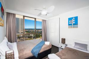 a hotel room with two beds and a window at Seacrest Beachfront Apartments Surfers Paradise in Gold Coast