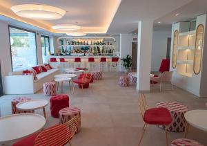 a restaurant with tables and chairs and a bar at Sol i Vida Hotel - Adults Only in Porto Cristo