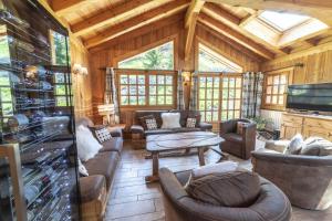 a large living room with couches and a tv at Chalet les trois coeurs in Méribel
