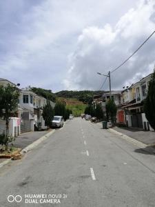 an empty street in a small town with houses at alyaleesya homestay Teres in Brinchang