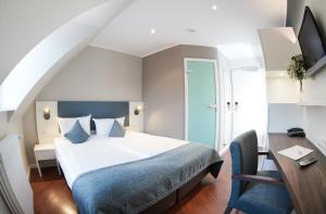 Postel nebo postele na pokoji v ubytování Stadthotel Freiburg Kolping Hotels & Resorts + 37 fotografií
