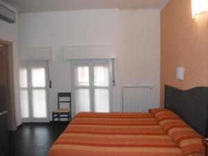 Postel nebo postele na pokoji v ubytování Hotel Renato