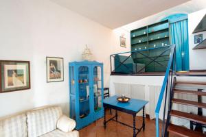 a living room with a blue cabinet and a table at Dammuso Cappero in Pantelleria