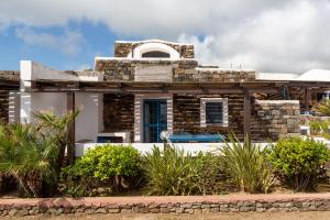 an old stone house with a swimming pool at Dammuso Cappero in Pantelleria