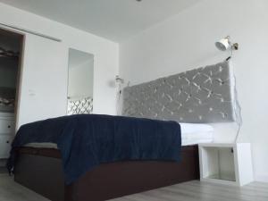 a bedroom with a bed with a blue blanket on it at AP TORRE in Torre de Moncorvo