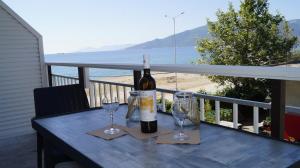 a table with two glasses and a bottle of wine at House Kohili in Nea Vrasna