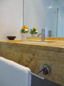 a bathroom counter with a sink and a mirror at Hotel Grecale in Porto Cesareo +38 photos