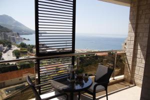 a balcony with a table and chairs and a view of the ocean at Montenegro Diamonds in Becici