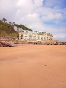 a building on the beach next to a sandy beach at Ocean View in Cawsand