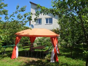 um guarda-chuva laranja em frente a uma casa em Guest House Raisa em Brest