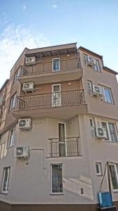 a tall building with balconies on the side of it at Хостел Атлас - Hostel Atlas in Blagoevgrad