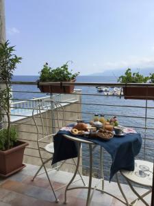 a plate of food on a table on a balcony at La Sciabica in Scilla