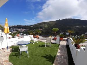 a patio with a table and chairs on a roof at Villa Flavia - Adults Only in Ponza