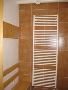 y baño con ducha y persianas de madera. en Penzion Jantoľák, en Zuberec