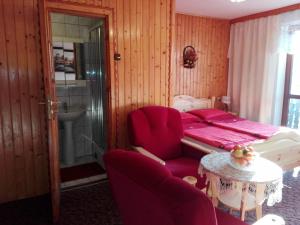 a bedroom with a bed and a table and chairs at Willa Katarzynka in Wisła