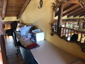 an office with a desk with a computer and a mirror at Villa Bonelli Bed & Fest in Savigliano