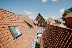 an aerial view of roofs of buildings in a city at Magni Boutique Hotel in Braunschweig