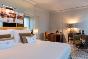 a bedroom with a large bed and a large mirror at Mandarin Oriental, Geneva in Geneva