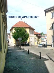 a sign for a house of apartment on a street at Central Apartment in Veszprém