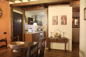 a kitchen with a table and a counter with a counter at La Casa del Abuelo Simón in Fuente el Sauz