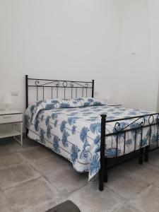 una camera con un letto e un piumone blu e bianco di Casa Vacanze Scicli Centro a Scicli