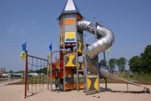 a playground with a slide in the sand at Kustpark Nieuwpoort in Nieuwpoort