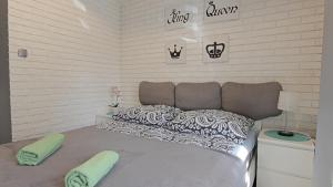 a bedroom with a large bed with two pillows on it at Apartament Tygrys in Zakopane