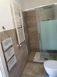a bathroom with a shower and a toilet at Casa del Moro in Cefalù +9 photos