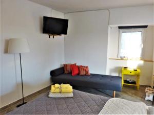 a living room with a couch and a flat screen tv at Studio apartmani Šverko in Punat