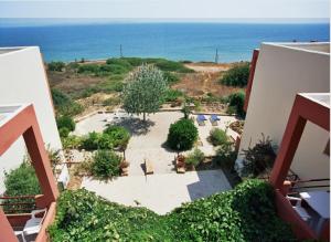 an aerial view of a courtyard with the ocean at Maria Rooms in Agia Ermioni