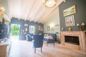 a living room with blue furniture and a fireplace at Villa Nitsa in Corfu