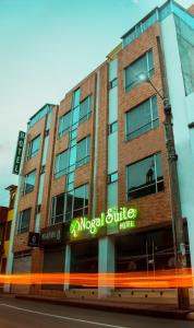 a building with a sign on the side of a street at Nogal Suite Hotel in Pasto