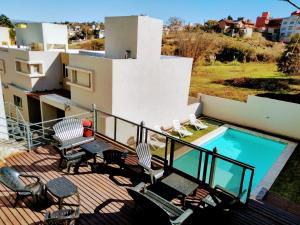 a balcony of a house with a swimming pool at Apart Porto del Sol by CPH in Villa Carlos Paz