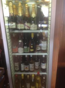 a refrigerator filled with lots of bottles of wine at Bois-raiguel chasseral in Corgémont