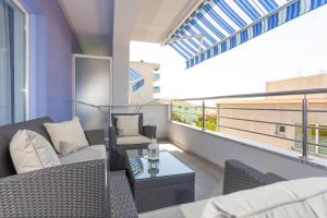 a balcony with a couch and chairs and a table at Blue House in Makarska